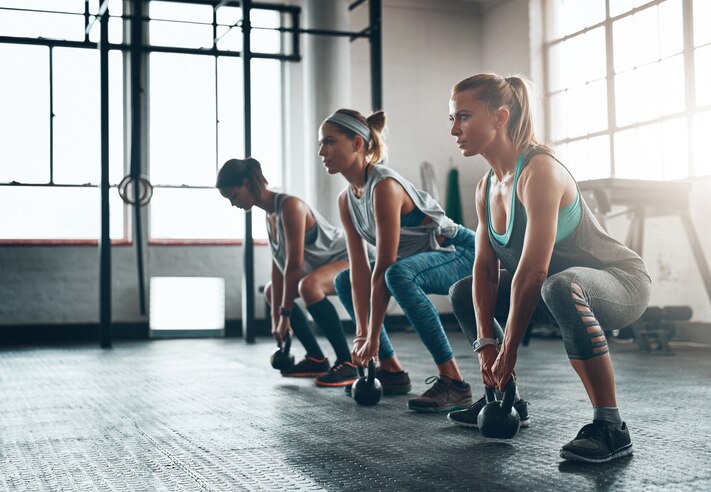 Shot of three young women working out together